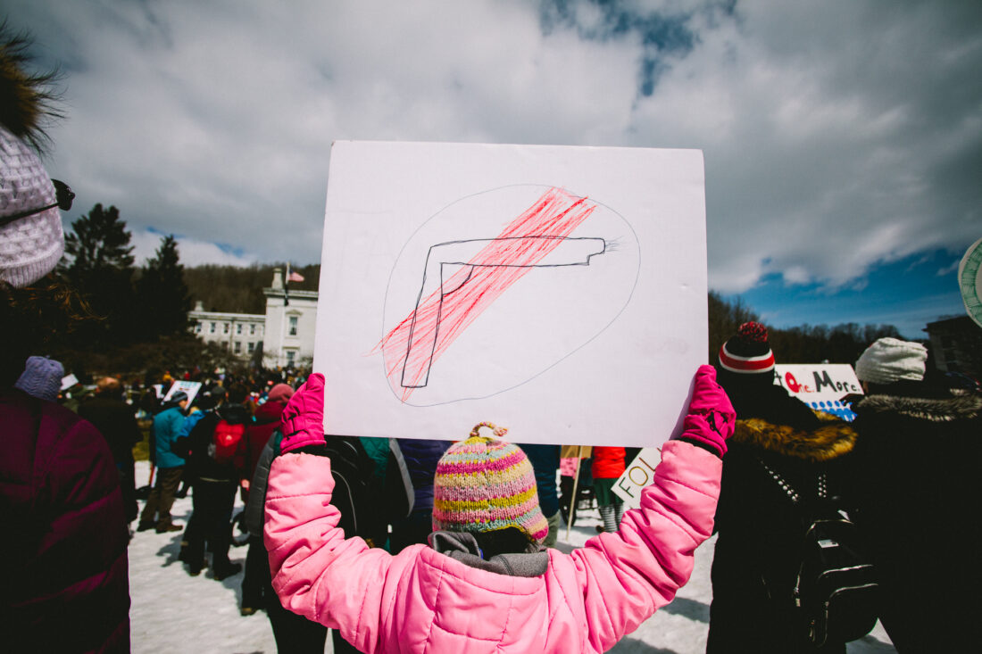 A girl holds a sign of a gun at the March for Our Lives March in Montpelier, VT