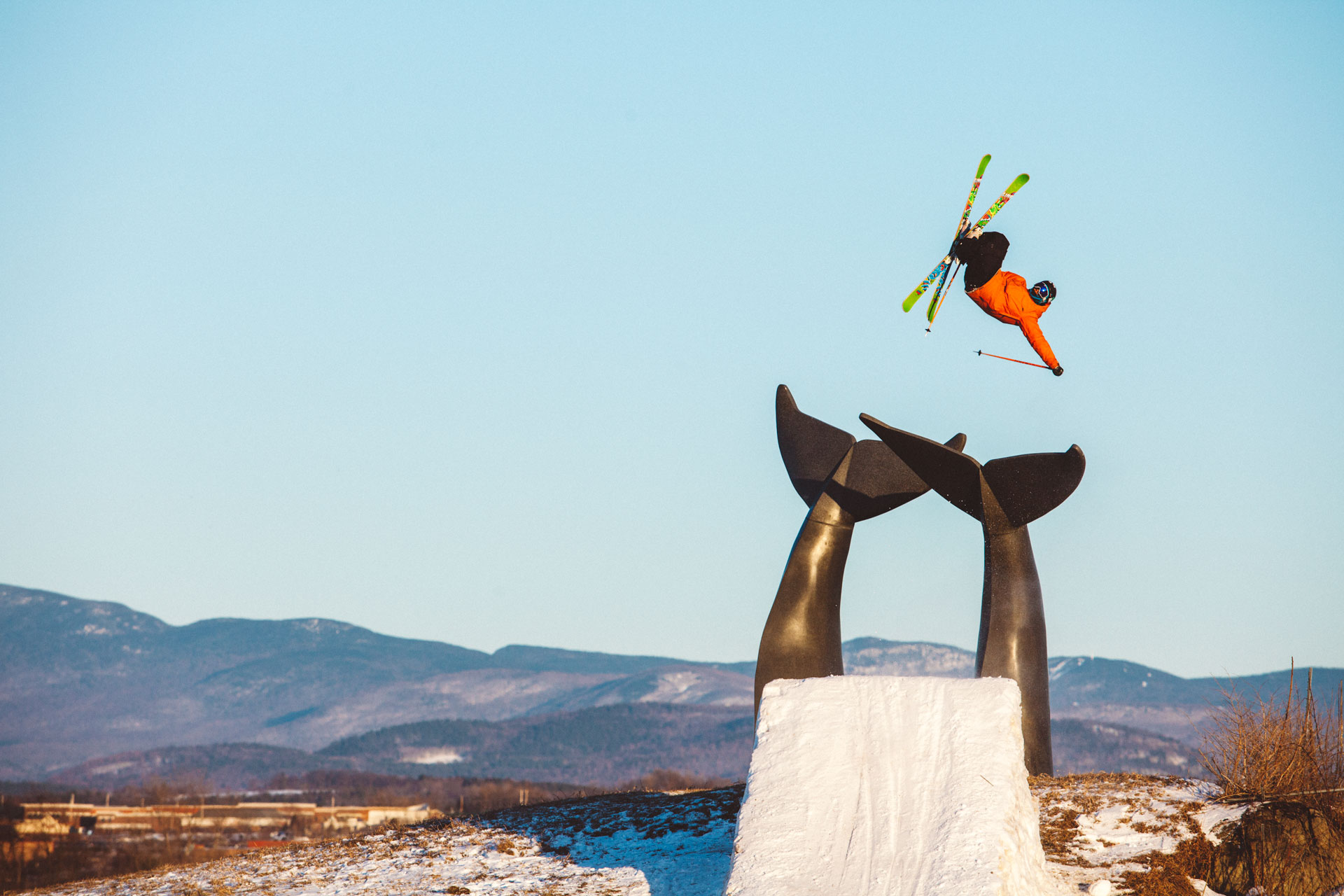 Skier jumps over Whales' Tail Sculpture