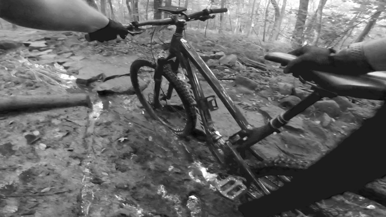 Mountain bike stuck in mud in black and white.