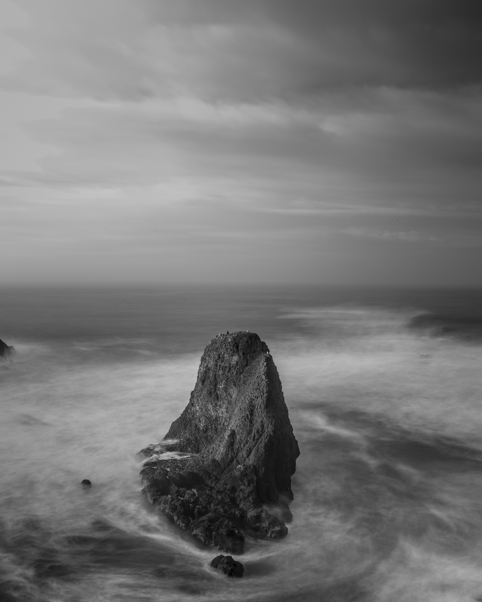 Black and white image of seastack Sea
